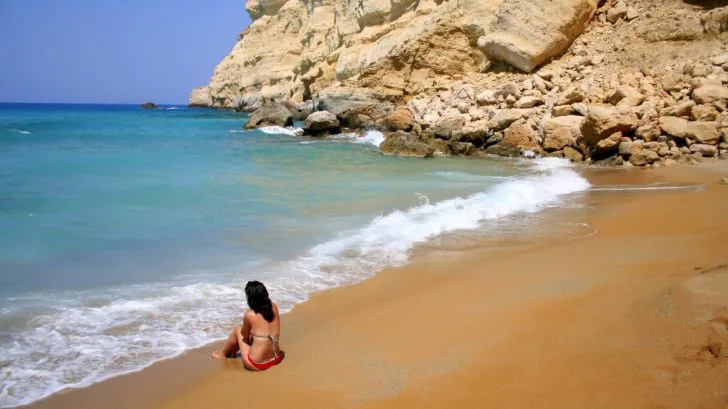 Topless woman at Red Beach, Crete, Greece